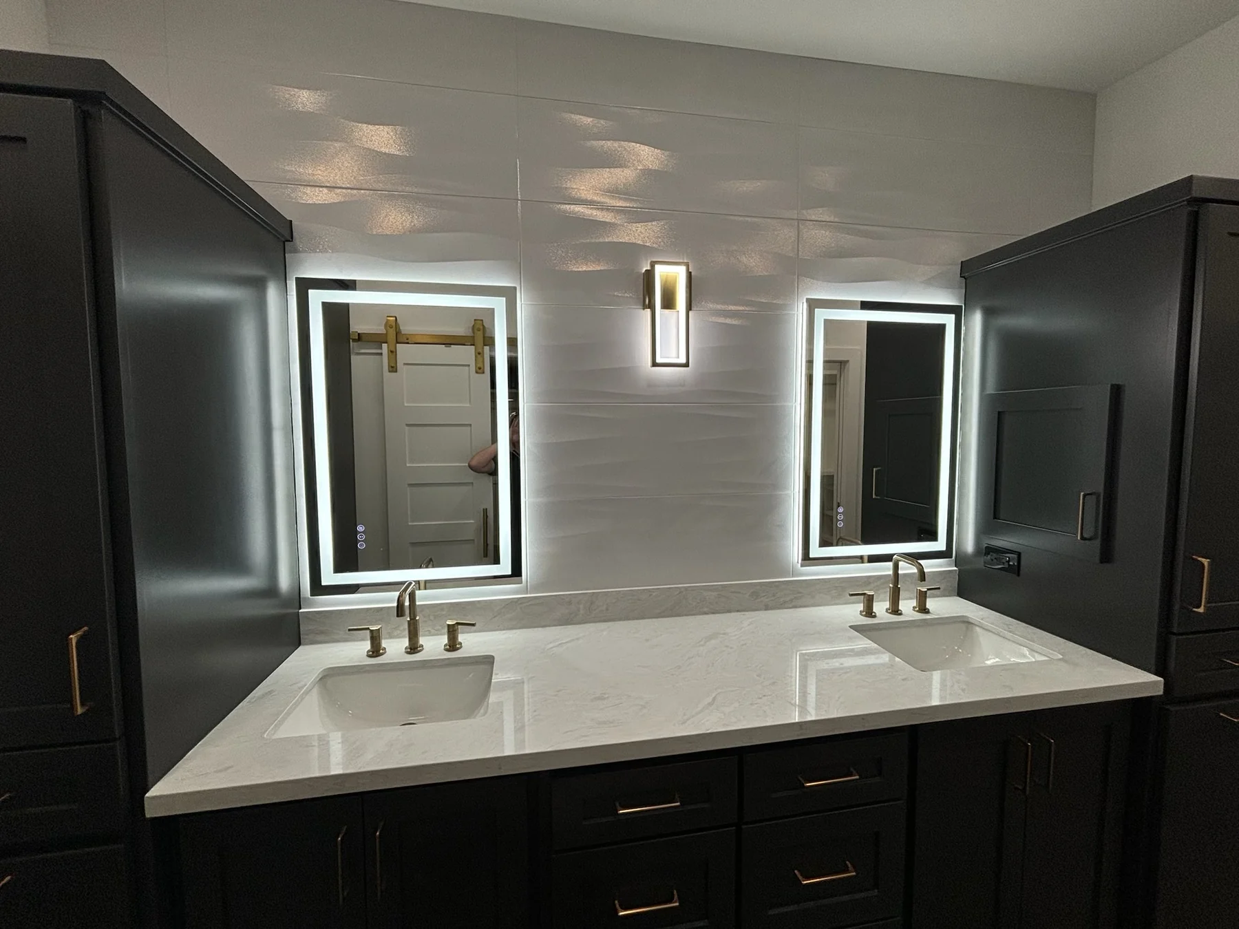 Custom double bathroom vanity with quartz countertop, LED mirrors and gold fixtures