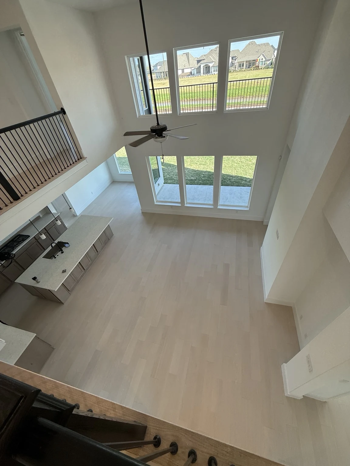 Engineered wood flooring across an open two-story living space