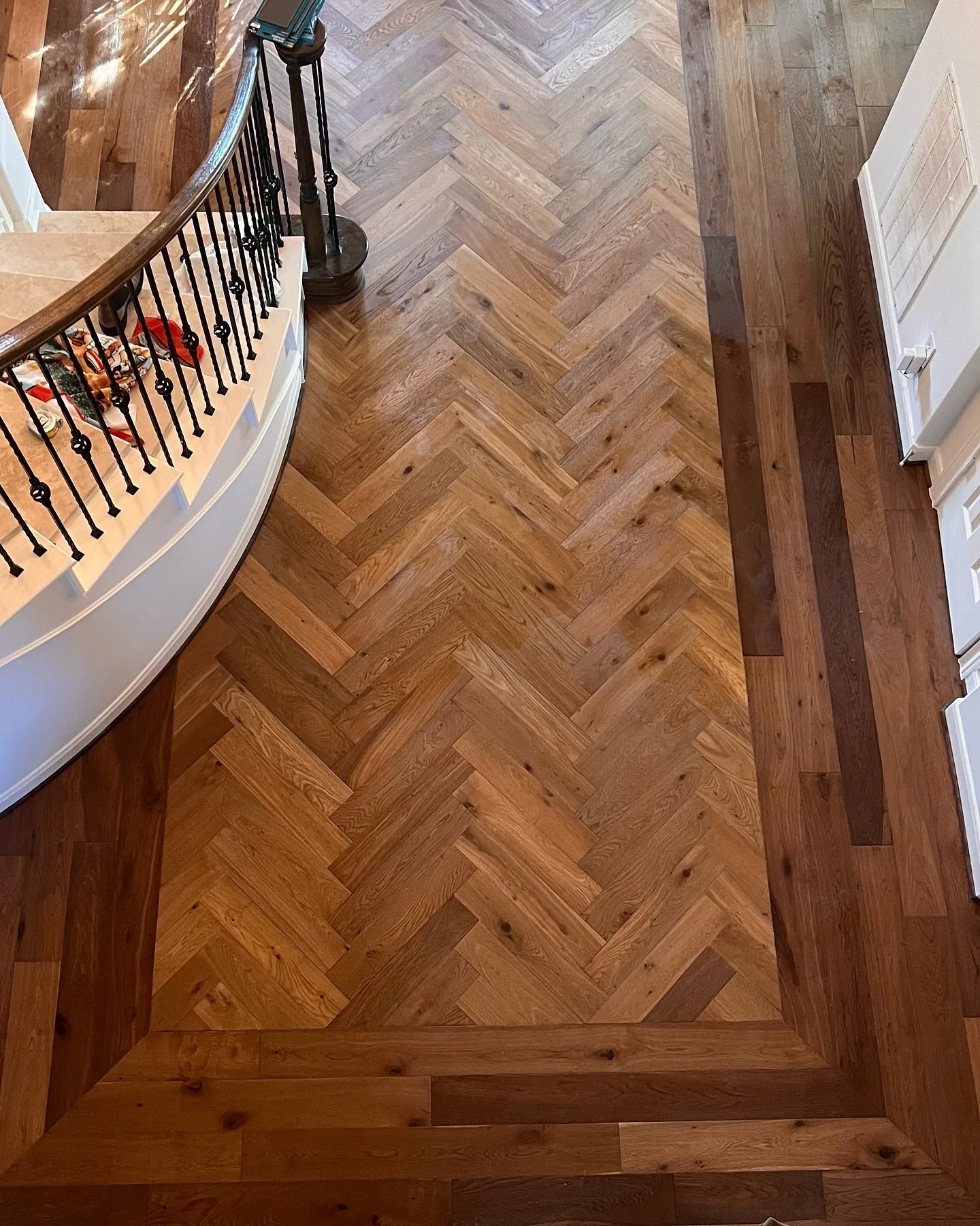 Custom herringbone engineered wood floor with border