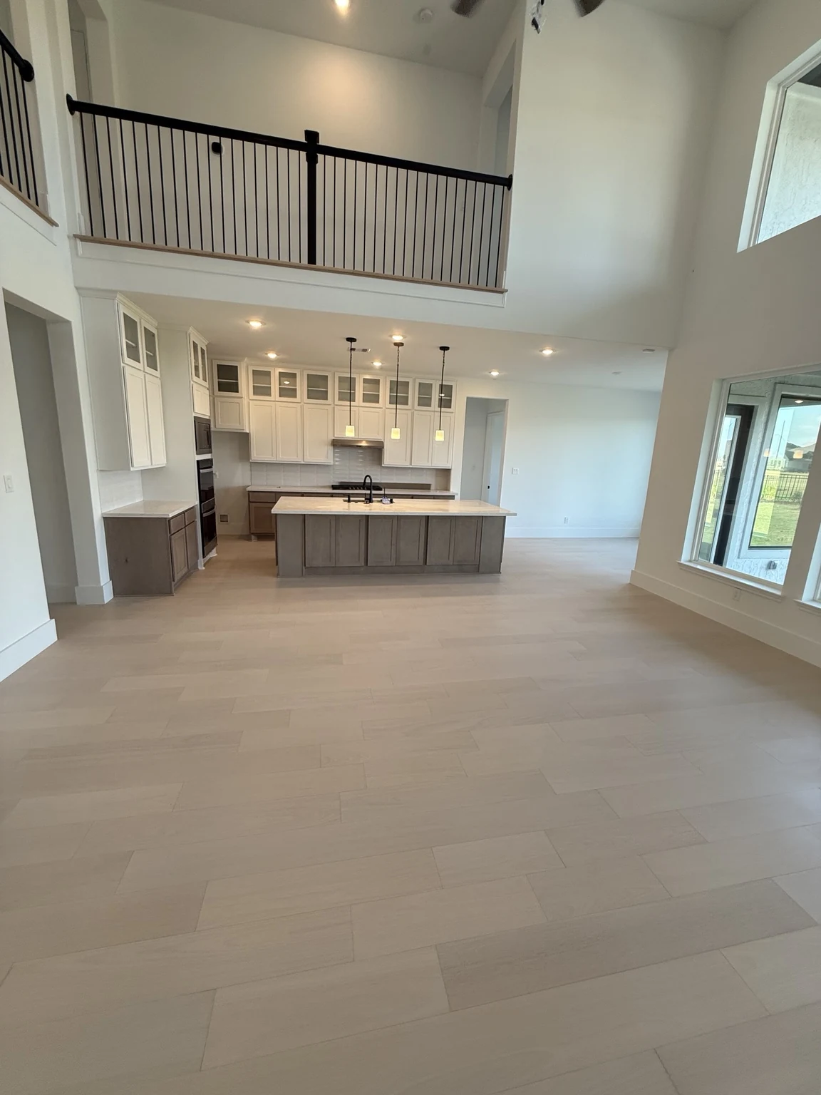 Bright open living room and kitchen with light engineered hardwood flooring