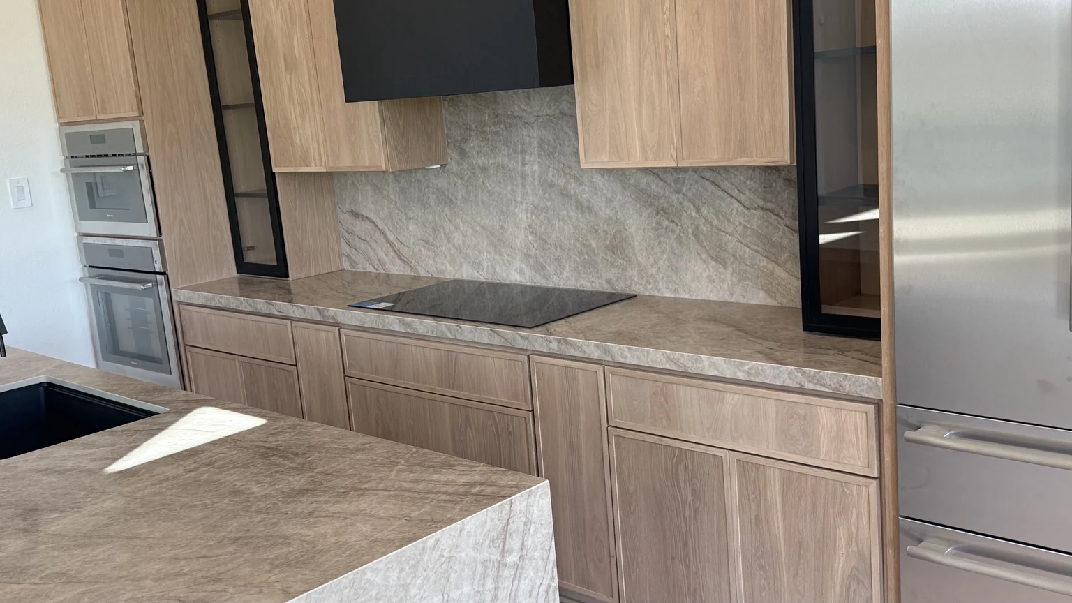 Natural wood cabinets with stone countertops