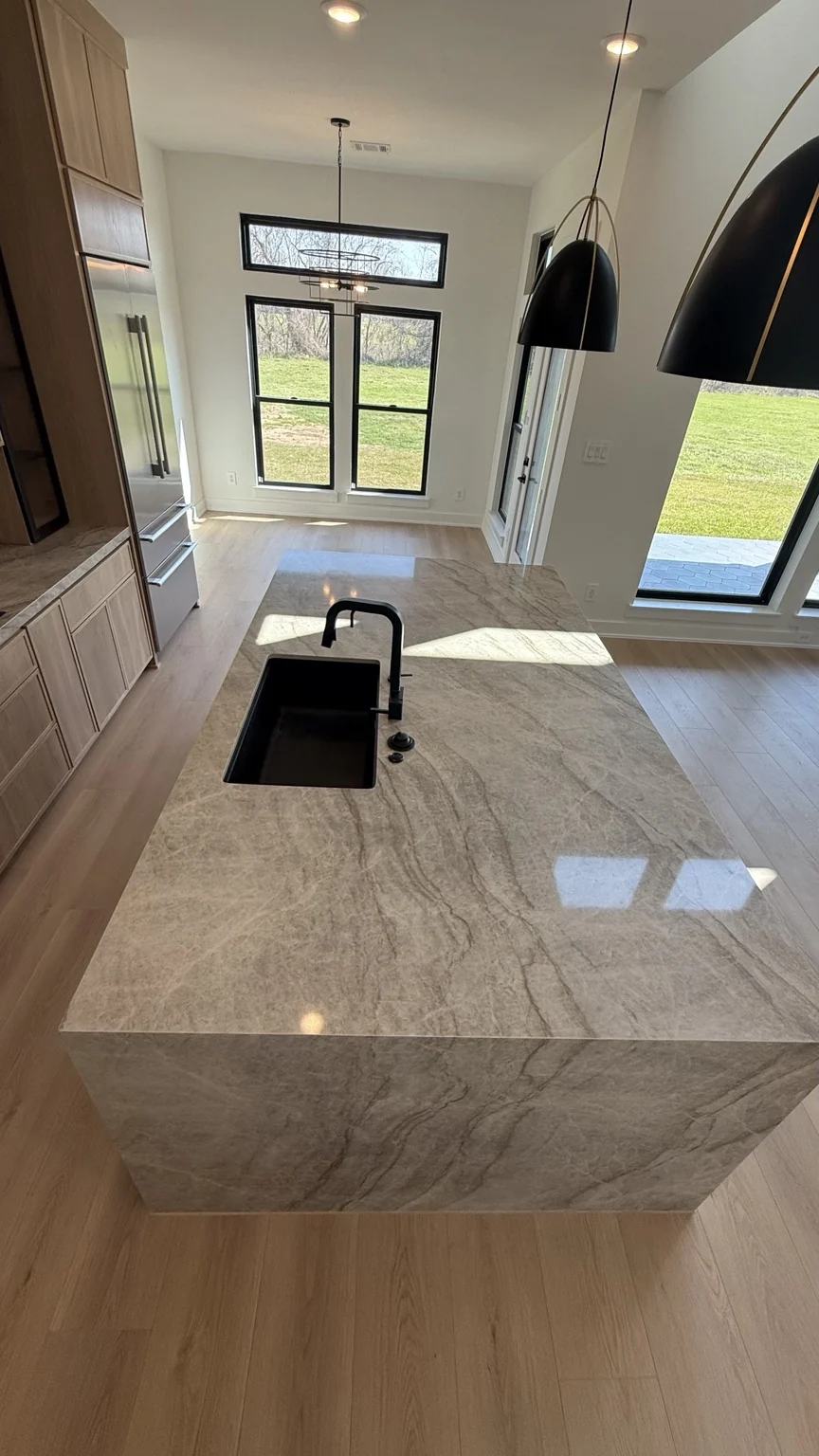 Large stone waterfall kitchen island