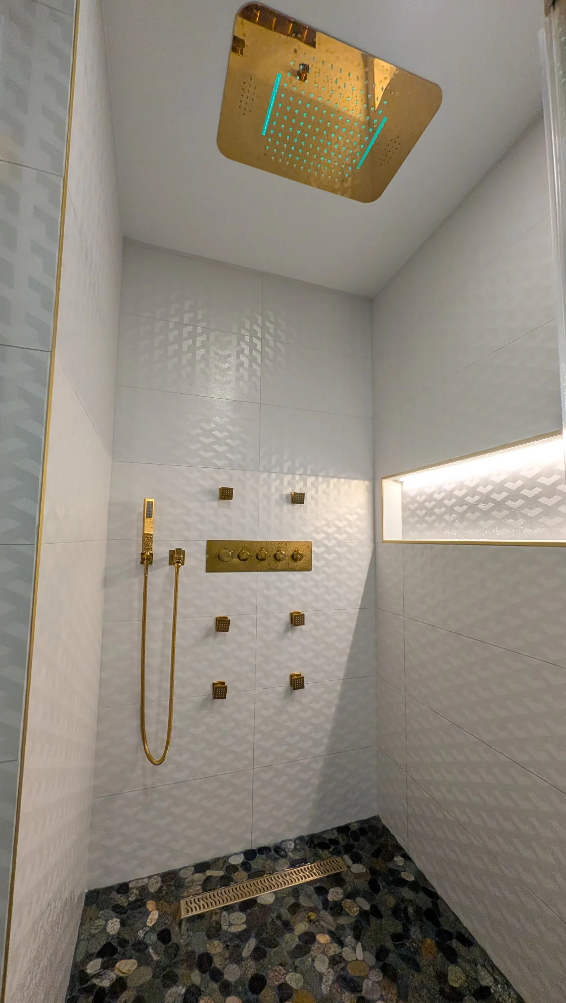 Custom shower tile wall with illuminated recessed niche