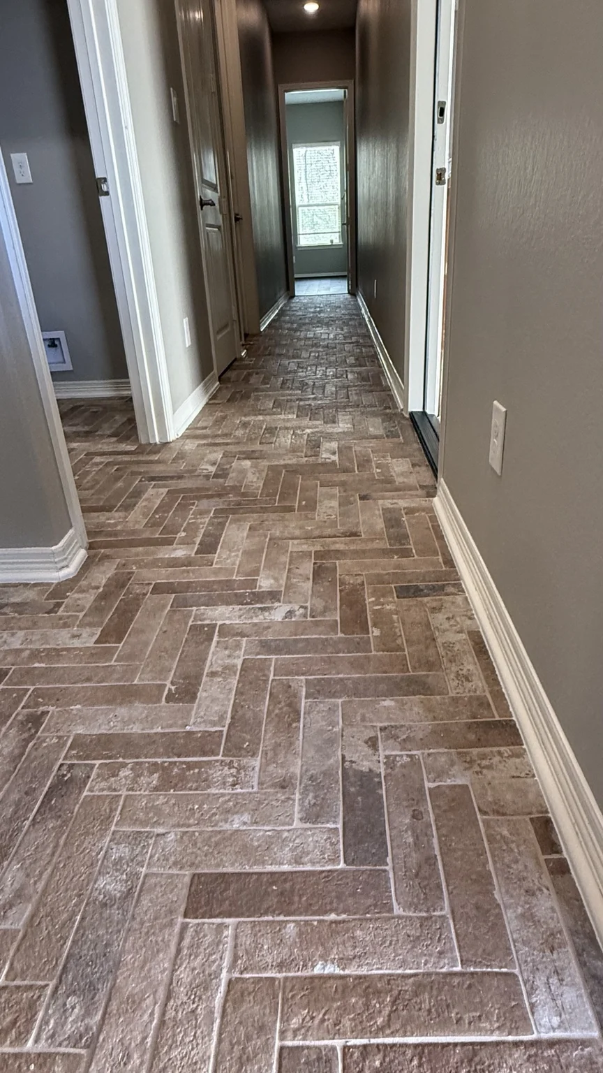 Hallway finished with multitone stone-look rectangular tile