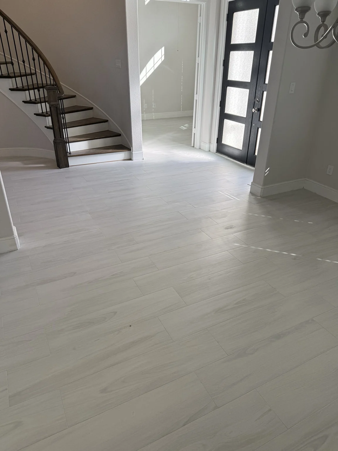 Light gray wood-look tile floor in home entryway