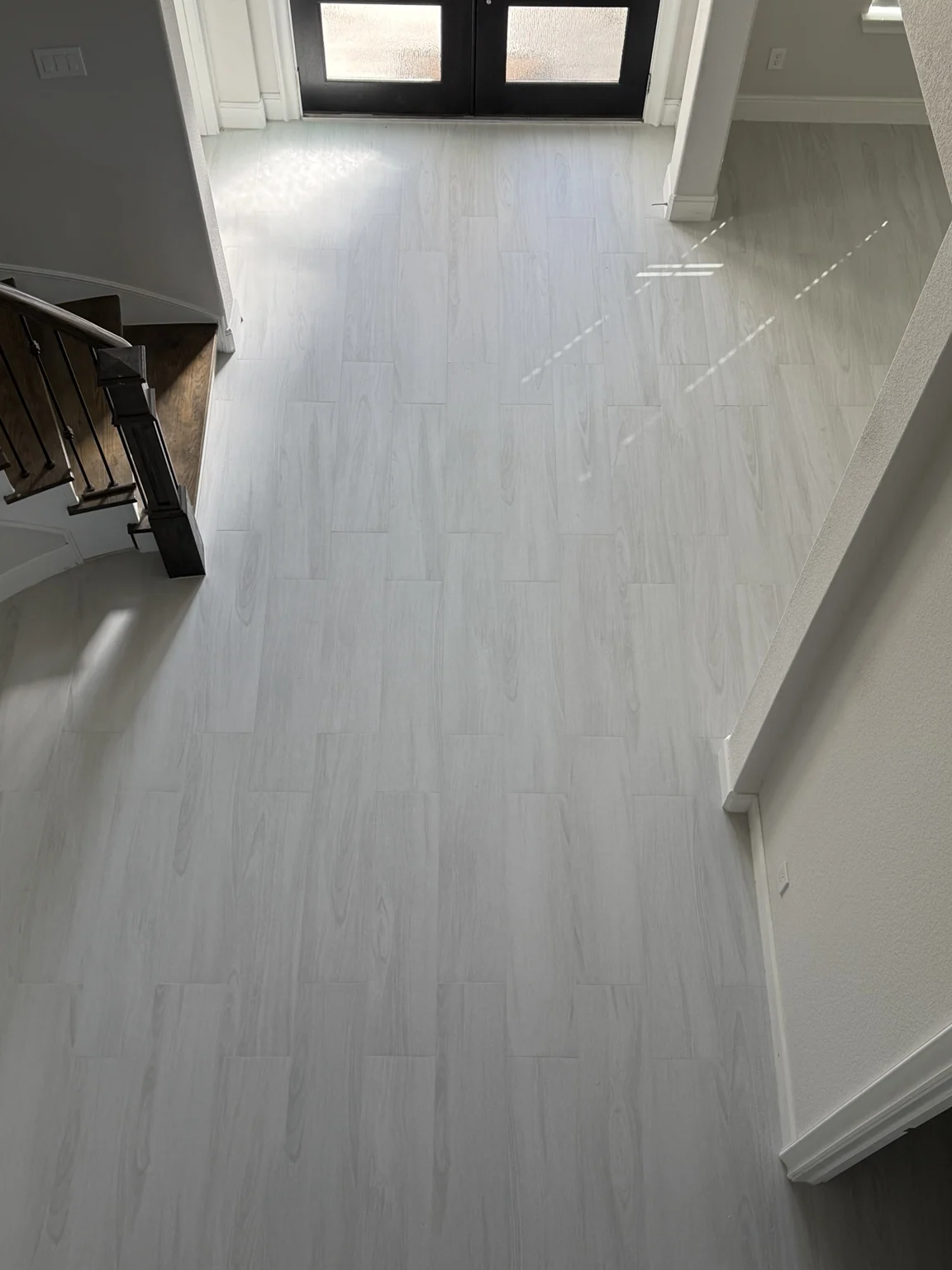 Pale wood-look tile flooring in residential hallway