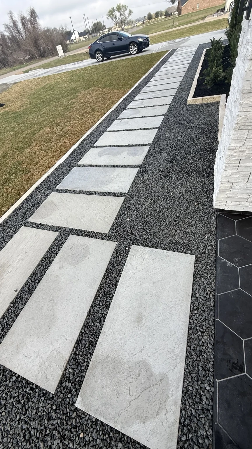 Outdoor entry with rectangular pavers and dark gravel accents