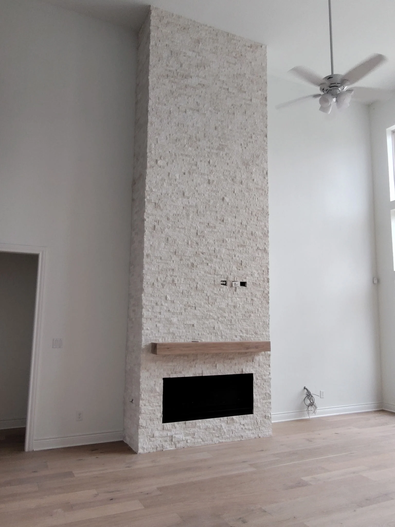 Light stone-look tile on fireplace feature wall