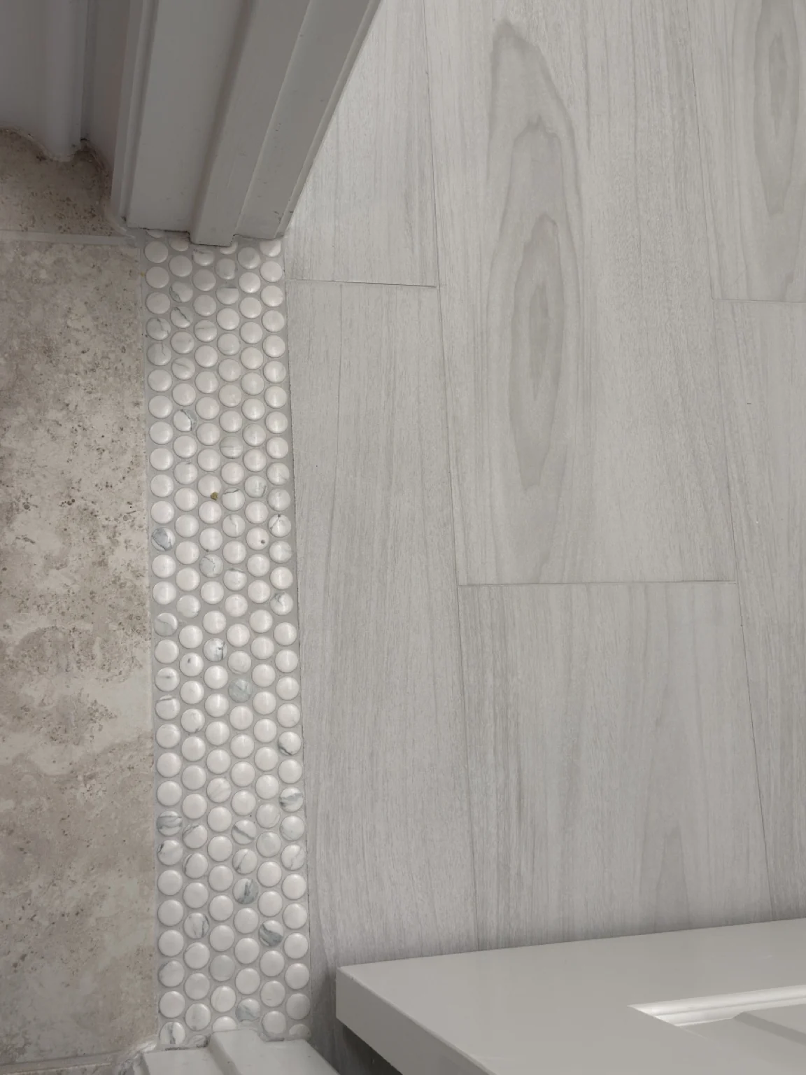 Vertical wood-look tile and mosaic accent wall
